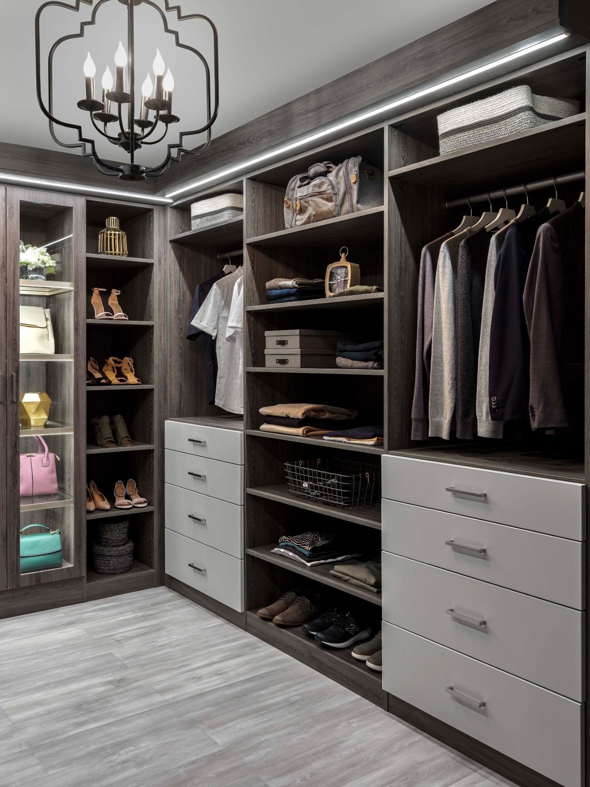 A walk in closet filled with lots of clothes and shoes.
