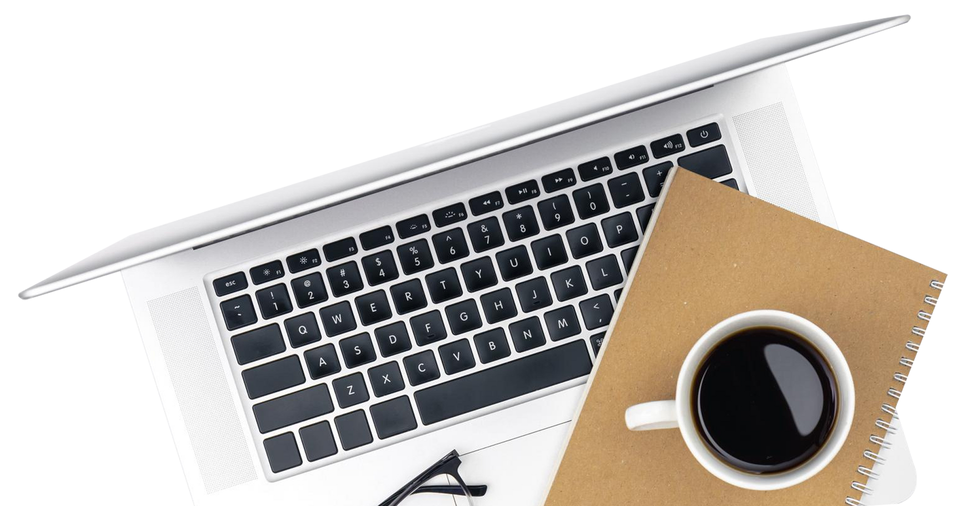 Laptop, coffee cup, and notepad on a white surface, overhead view.
