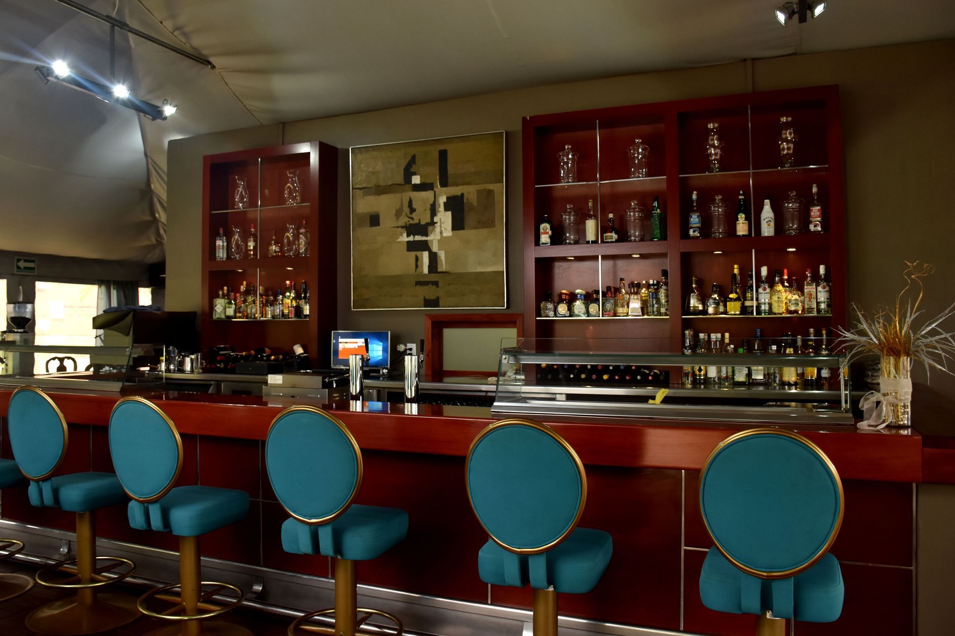 Un bar con muchas botellas en los estantes.