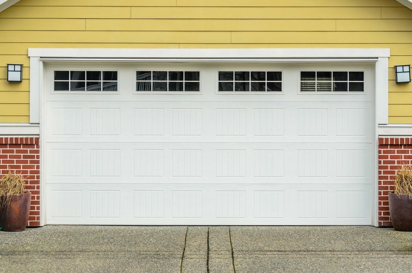 White Garage Doors — House And Driveway in Appleton, WI