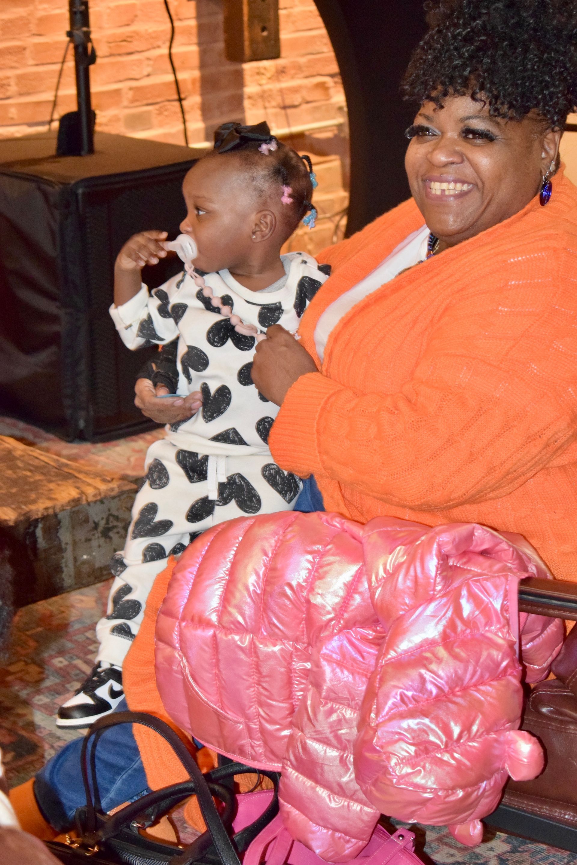 A Woman Is Sitting on A Couch Holding a Baby — Saint Louis, MO — Priority One Healthcare Services