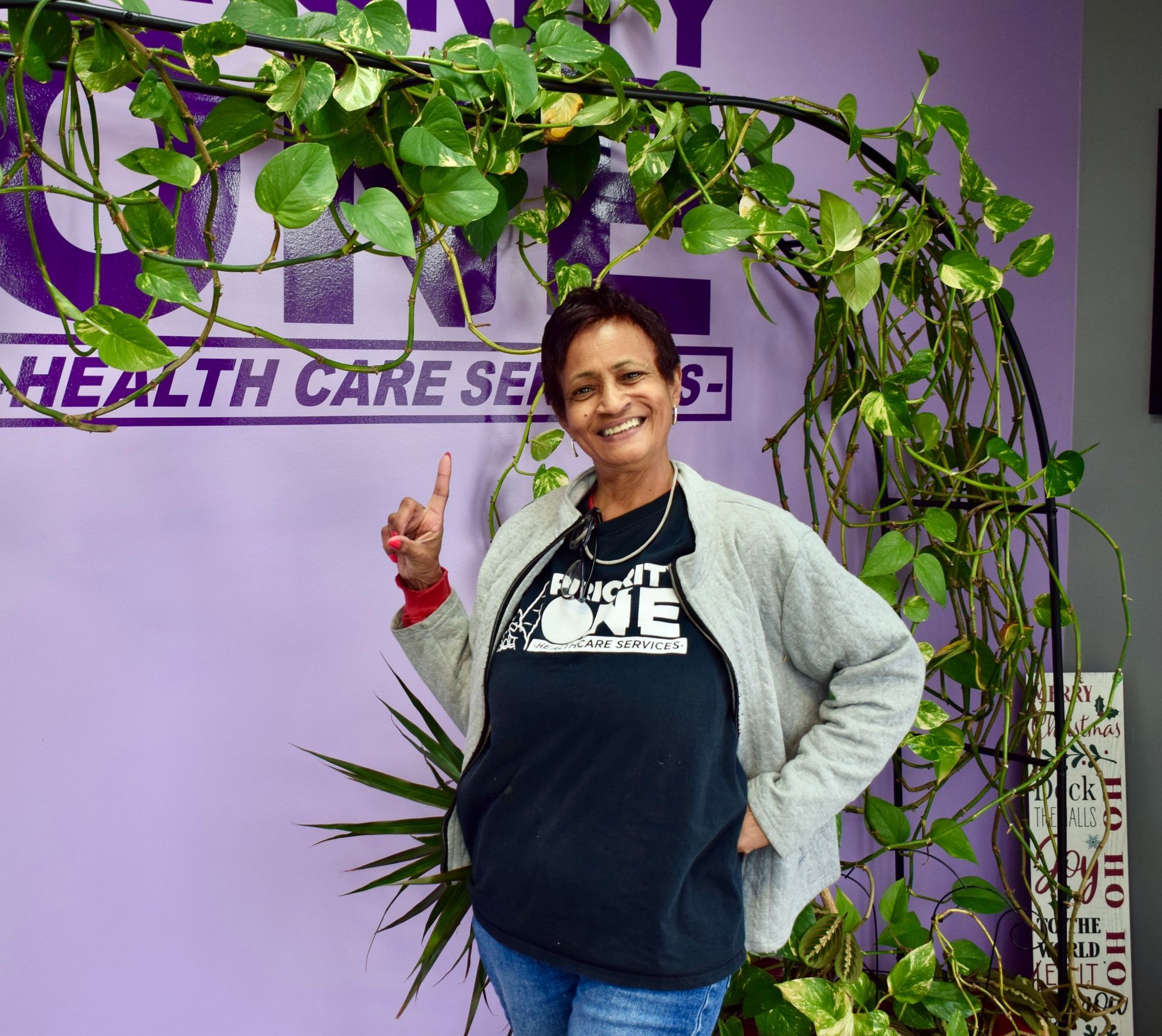 A Woman Is Standing in Front of A Sign that Says Health Care Services