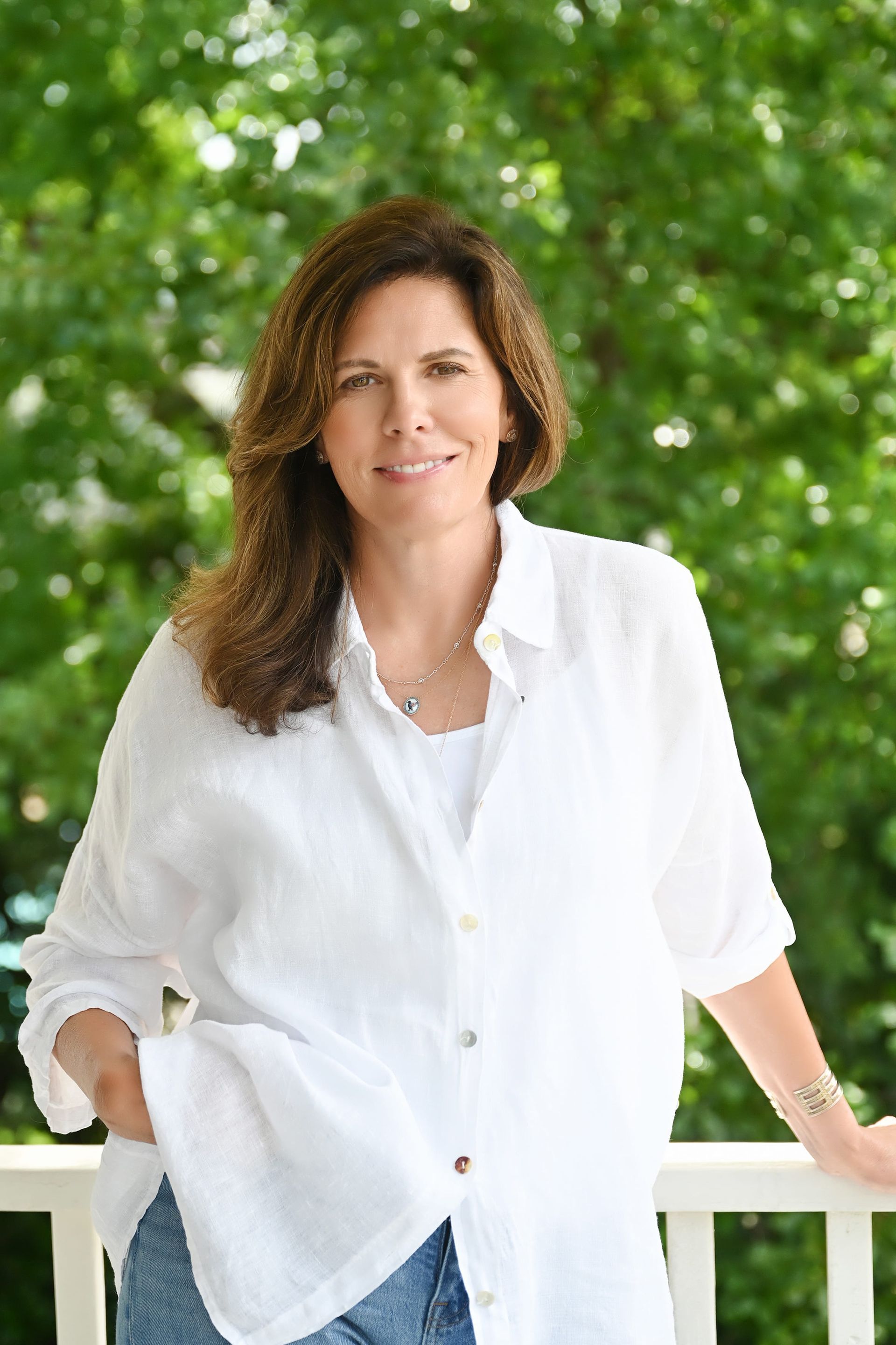 Jamie Hartman, Founder and Therapist at The Nine Therapy, smiling in the doorway of her office in Charleston, SC.