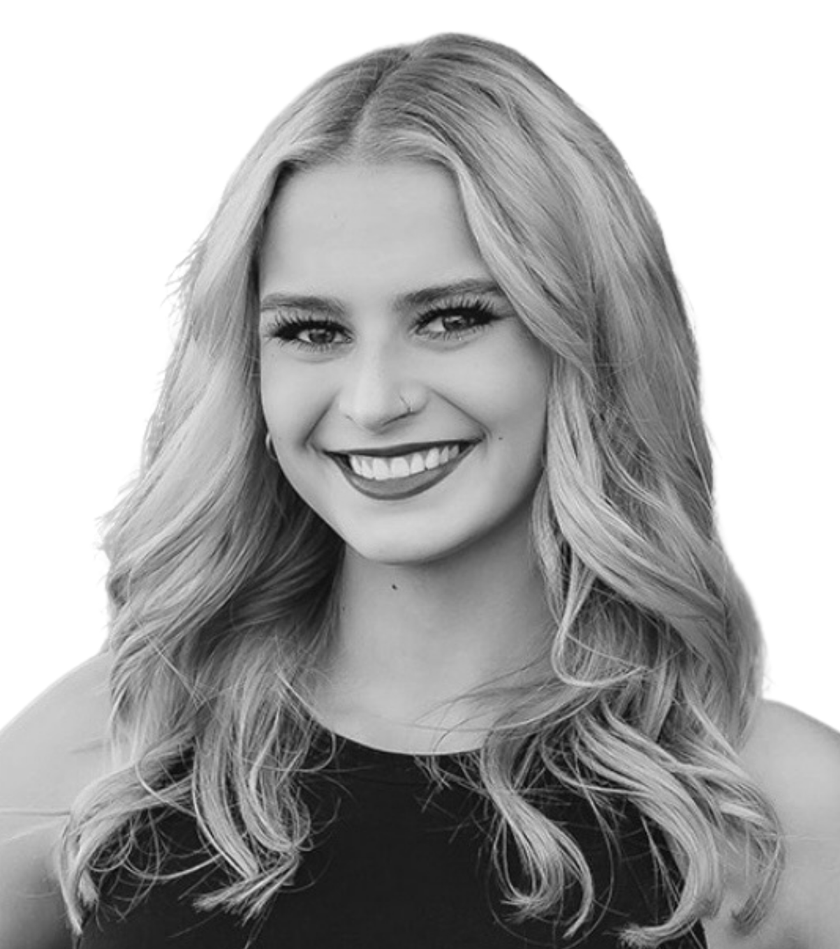 Black-and-white portrait of a smiling person with wavy hair and a dark sleeveless top.