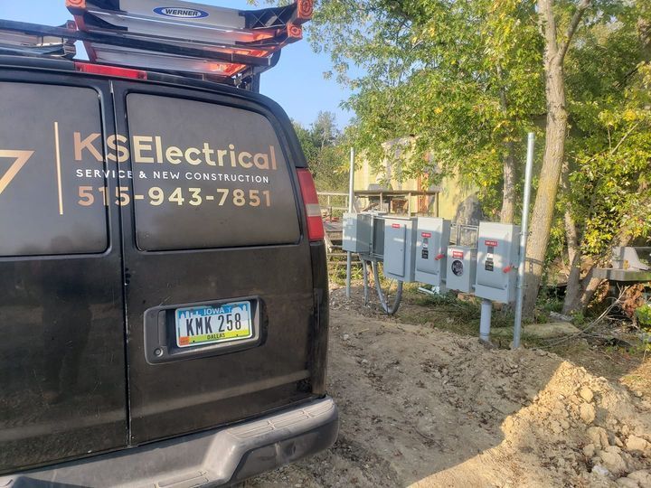 A black van with ks electrical written on the back