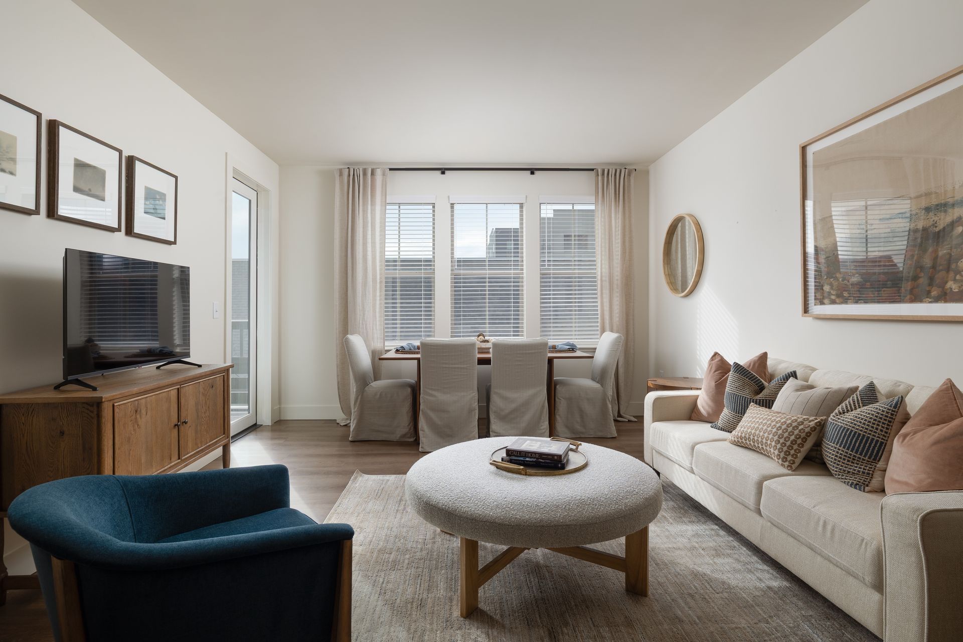 A man and a woman are sitting on a couch eating popcorn