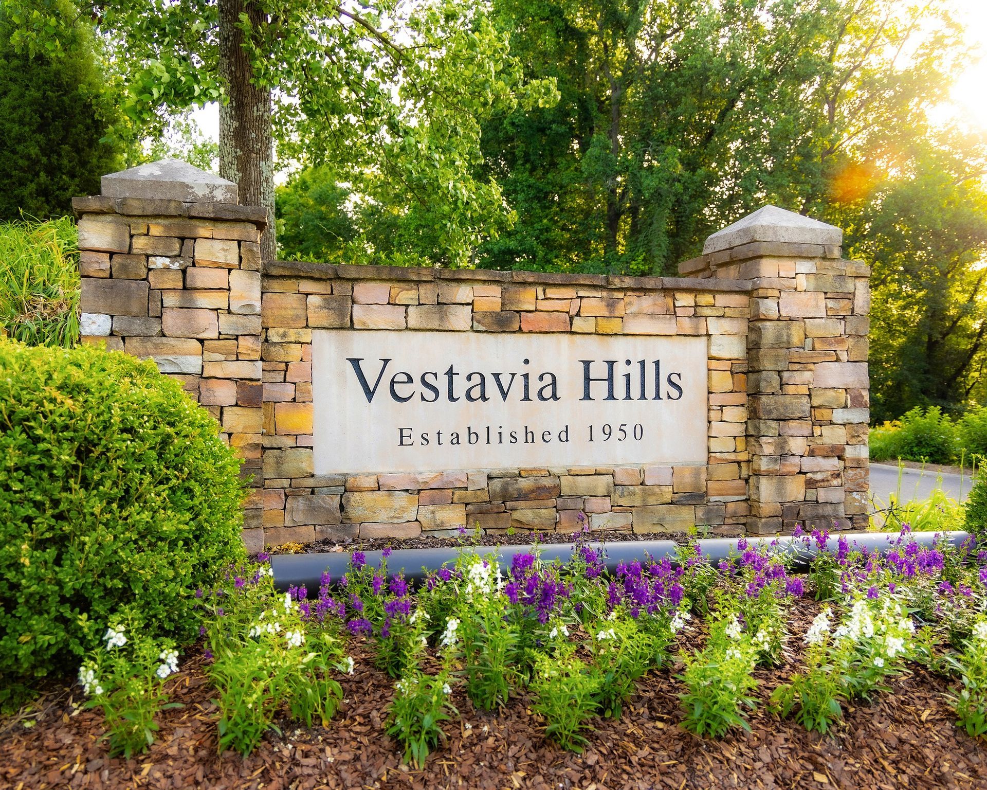 People at a Christmas dinner table. Trees, candles, and a chandelier in the room.