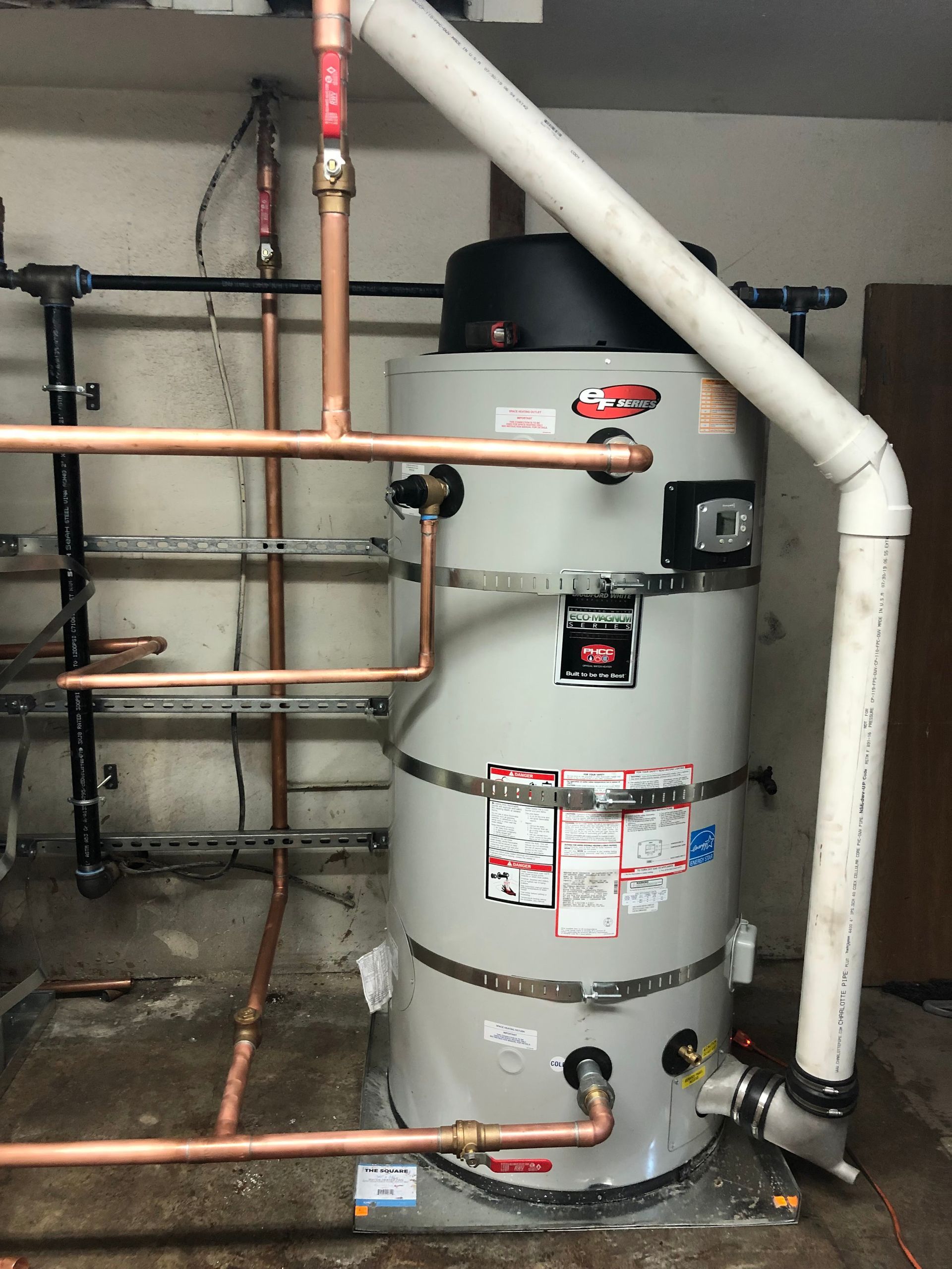 Rightway Plumbing Sewer And Drain - A water heater with copper pipes attached to it