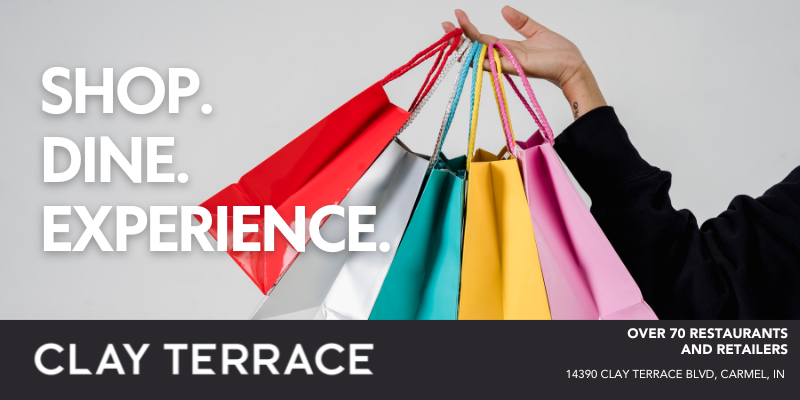 A hand holds up colorful shopping bags beside text reading 