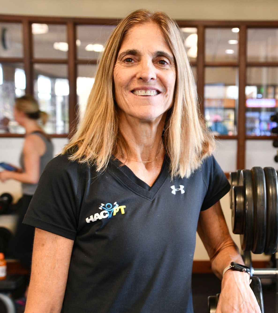 a woman wearing a black shirt that says hacpt