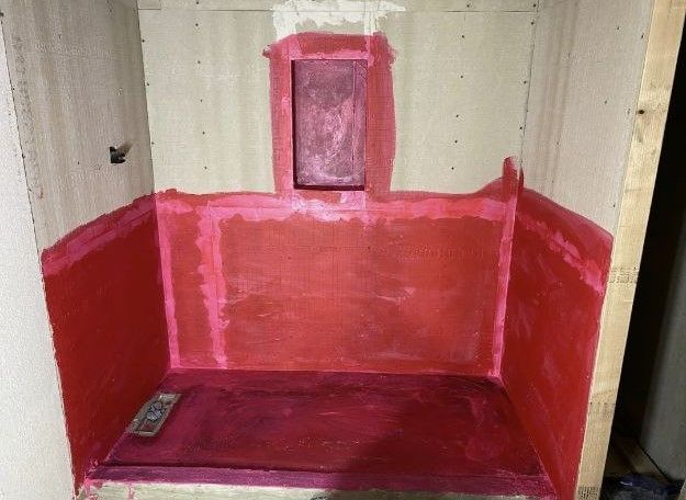 A bathroom with red paint on the walls and floor.
