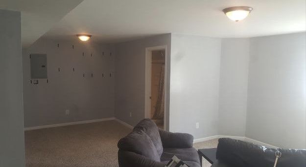 A living room with a couch , chair , and table.