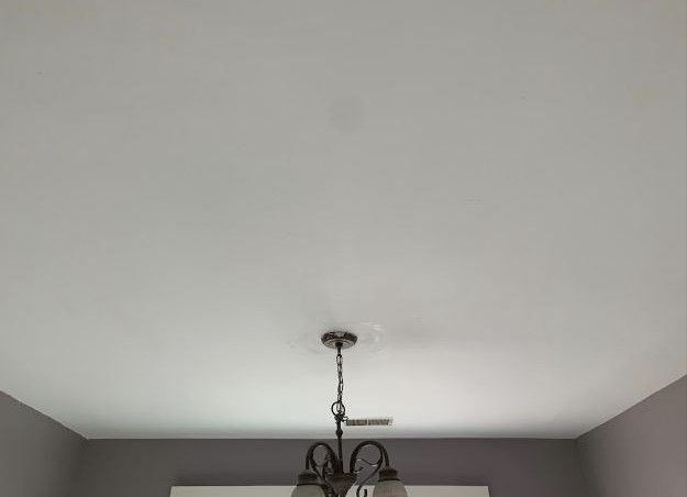 A chandelier is hanging from the ceiling of a room.