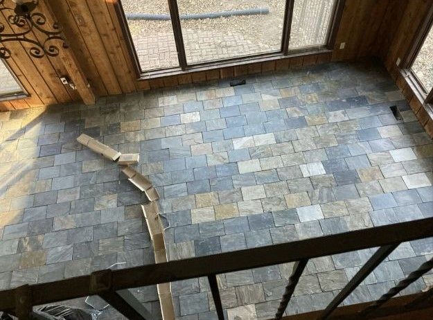 A view of a tiled floor from the second floor of a house.