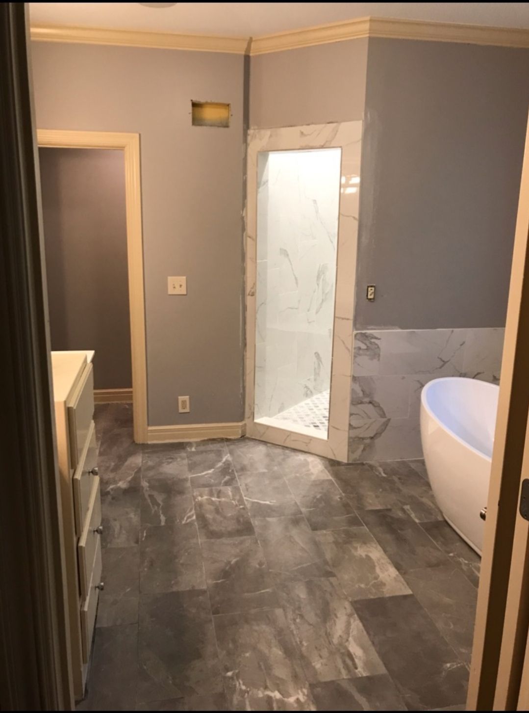 A bathroom with a bathtub and a walk in shower