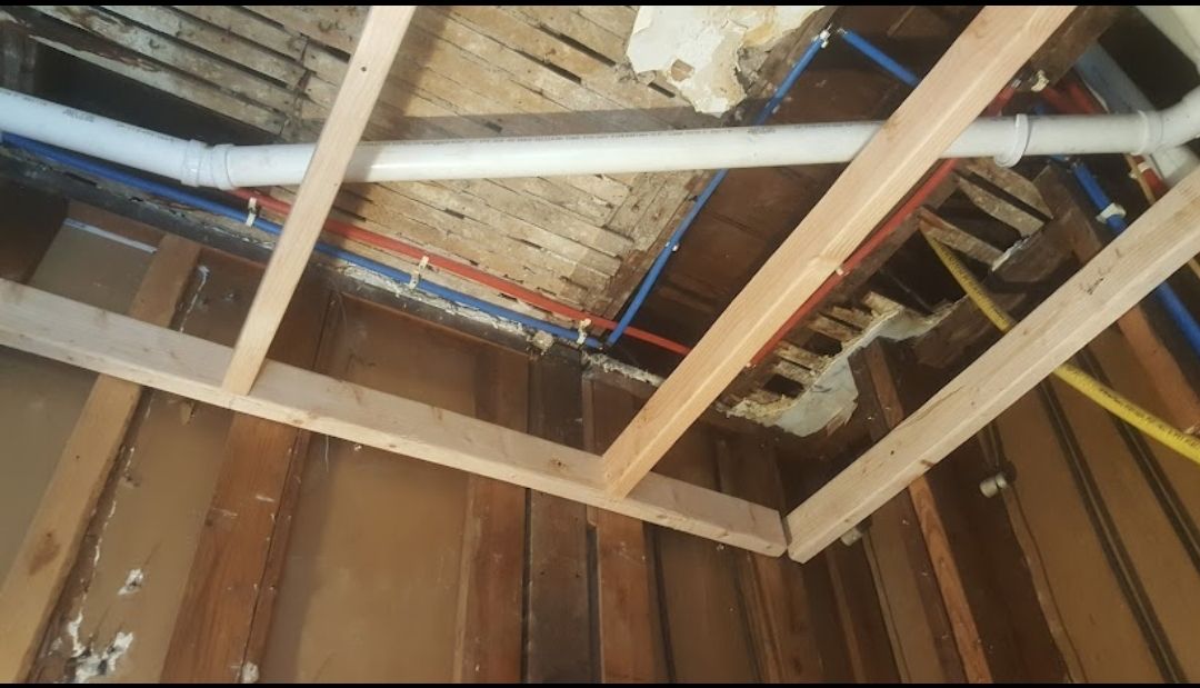 A room with a lot of pipes hanging from the ceiling.