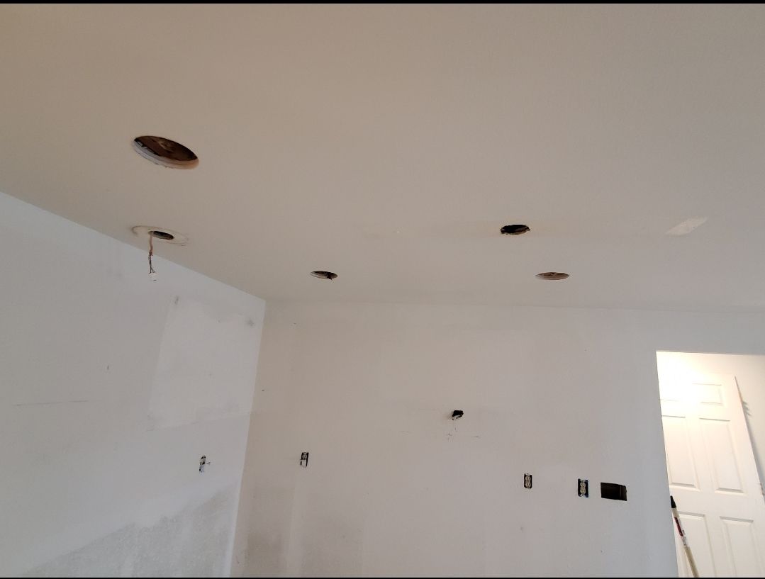 A room with a ceiling that has holes in it