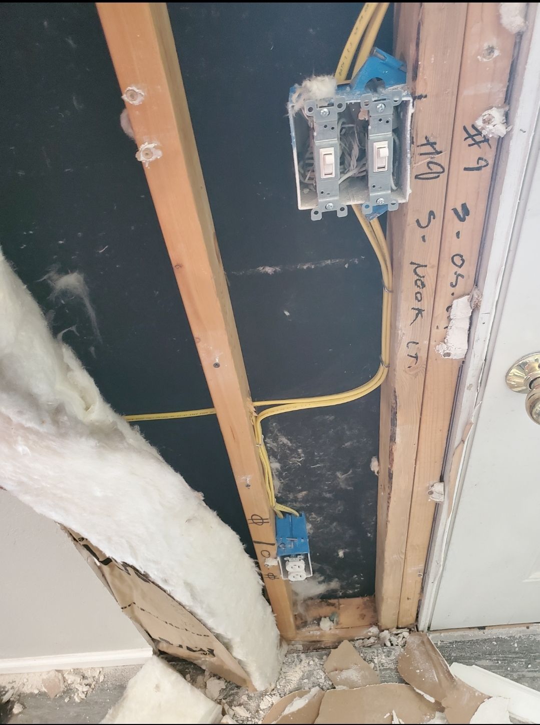 A box of wires is hanging from the ceiling of a room.