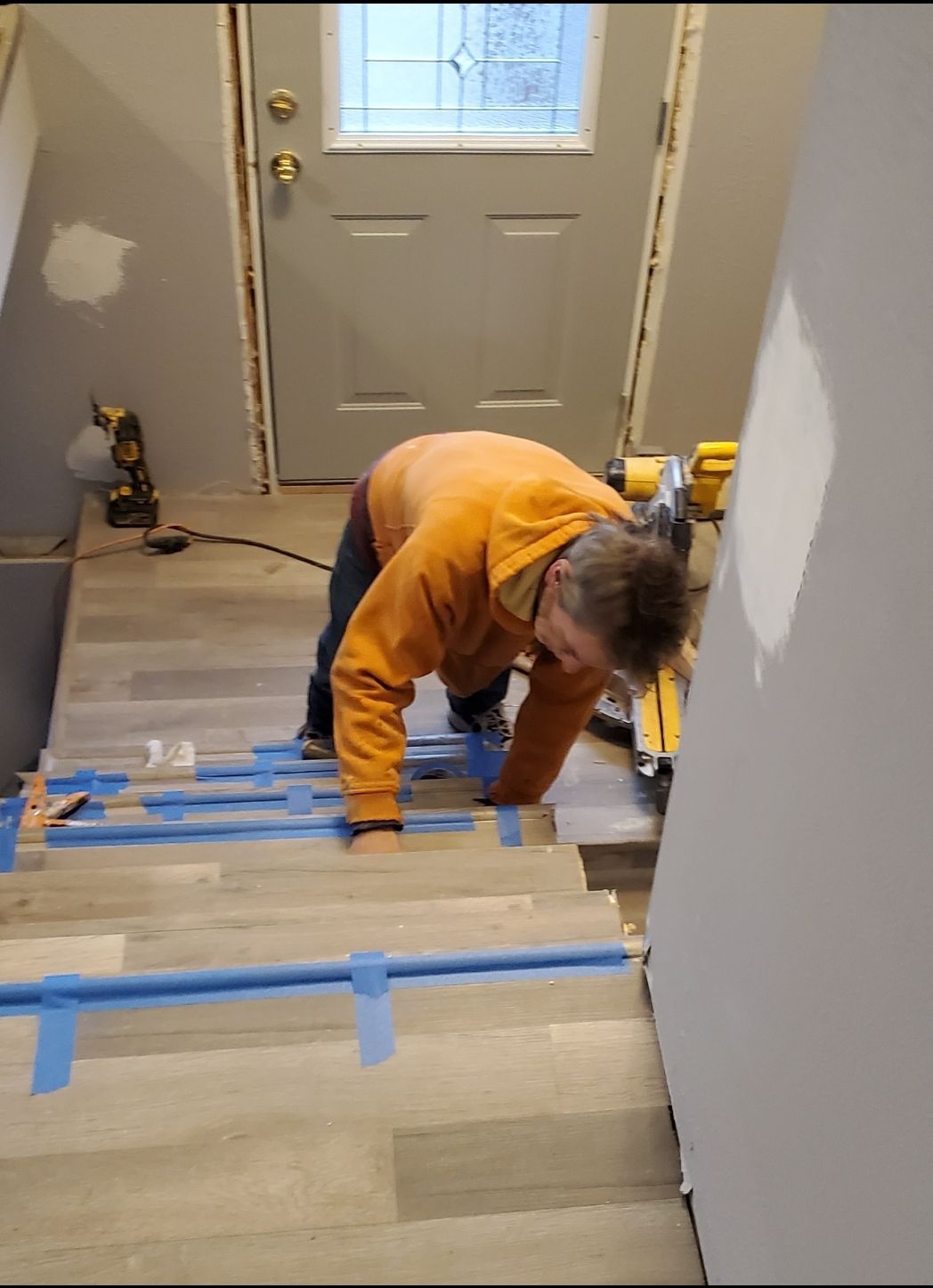 A man is working on a set of stairs.