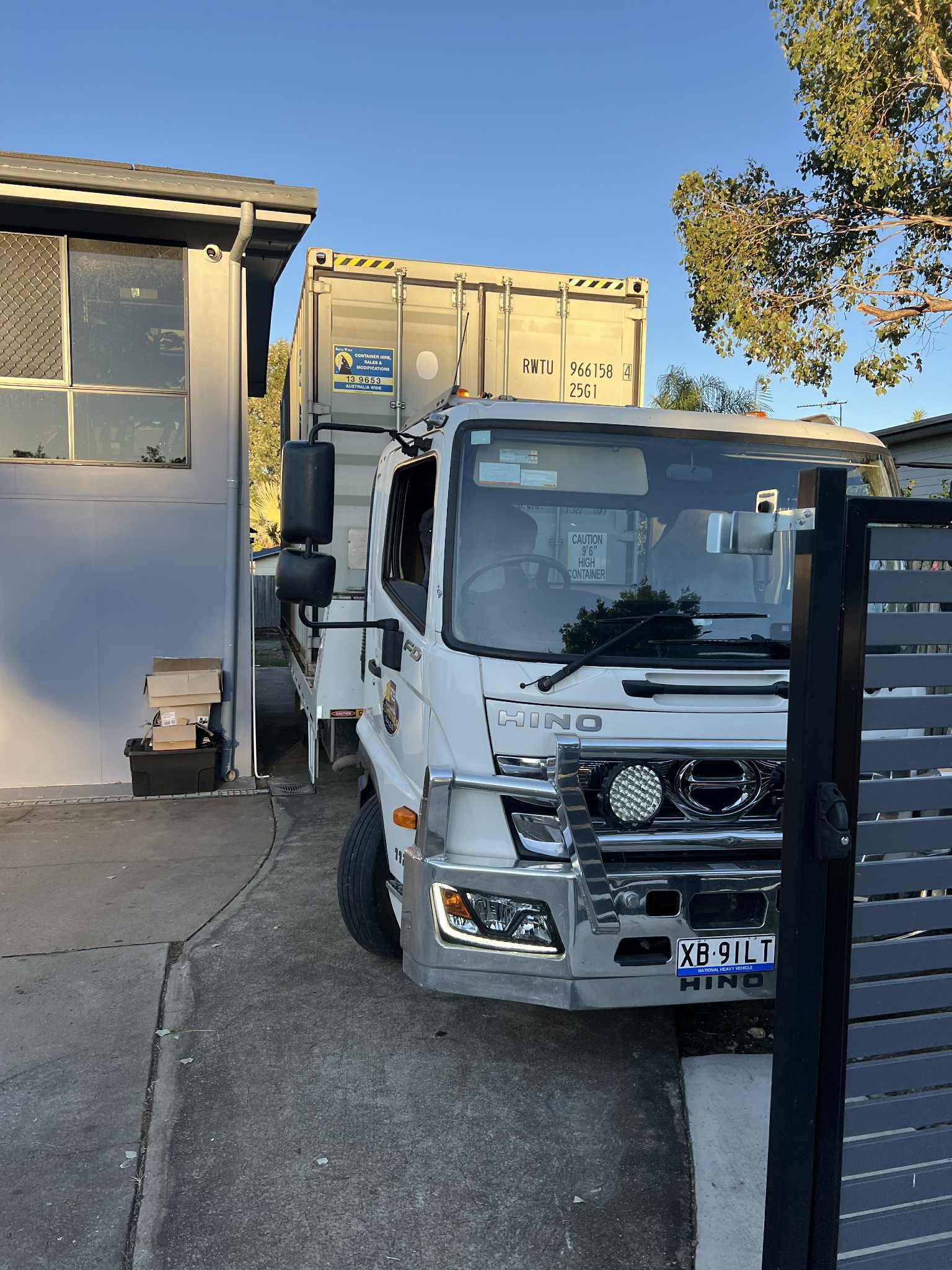 White Hino Truck With a Container on Its Flatbed Parked — Rockhampton Container Sales in Kawana, QLD