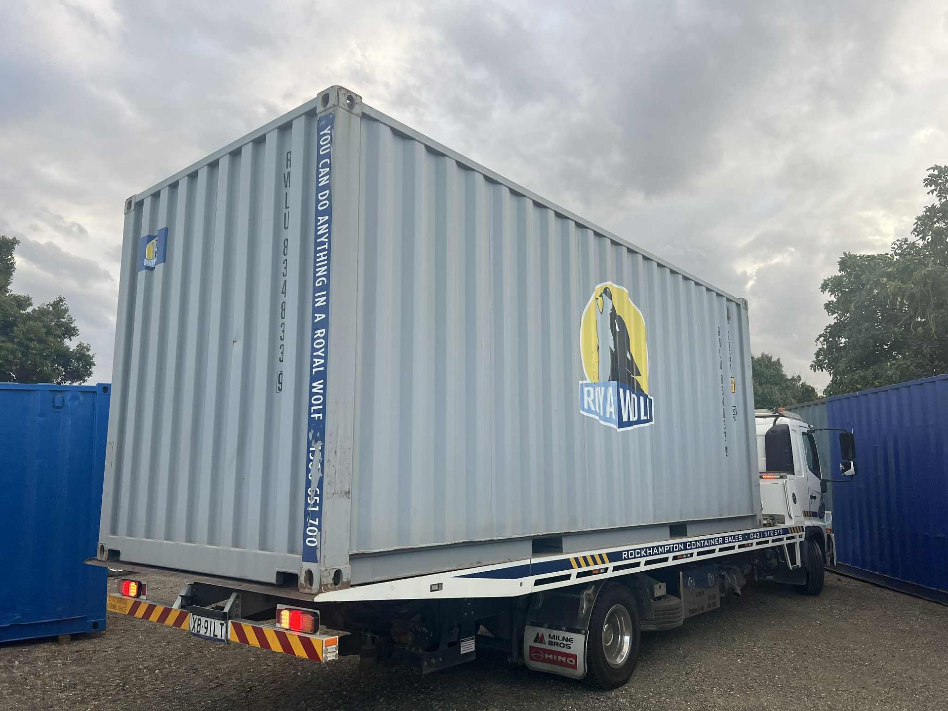 a Light Blue Shipping Container on a Flatbed Truck — Rockhampton Container Sales in Kawana, QLD