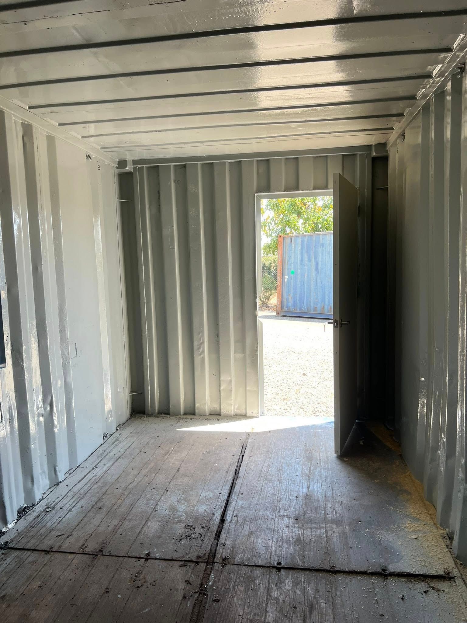 Interior of a Painted Shipping Container. Doorway Open to Outside — Rockhampton Container Sales in Kawana, QLD