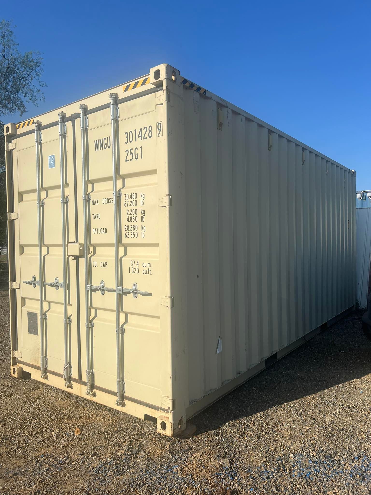 Tan Shipping Container on Gravel Against a Clear Blue Sky  — Rockhampton Container Sales in Kawana, QLD
