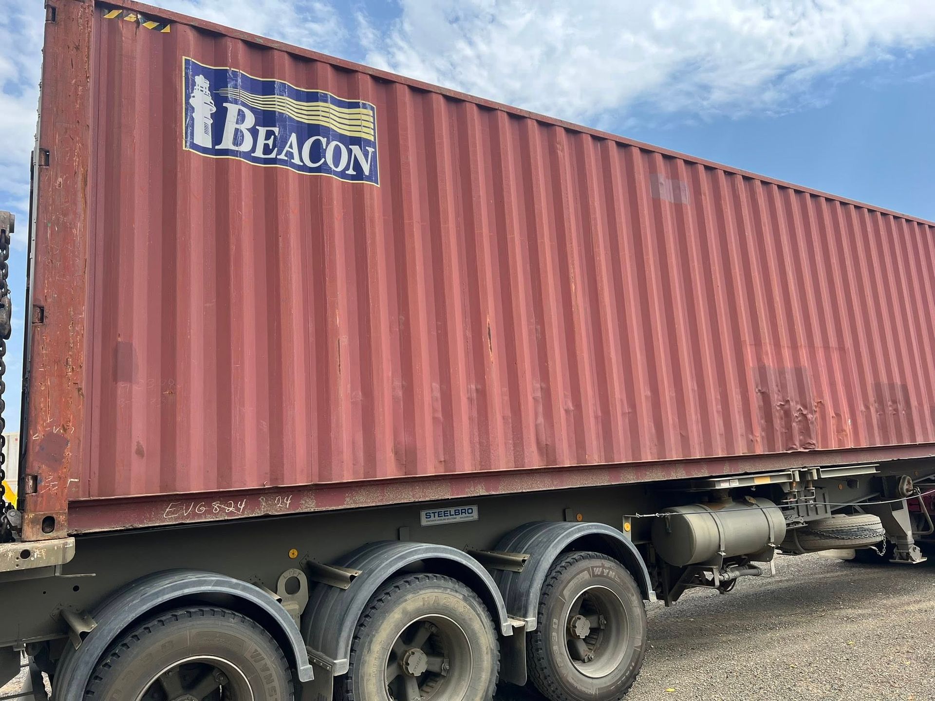 Blue Shipping Container on a Truck, Door Closed, Against a Sunny Blue Sky  — Rockhampton Container Sales in Kawana, QLD