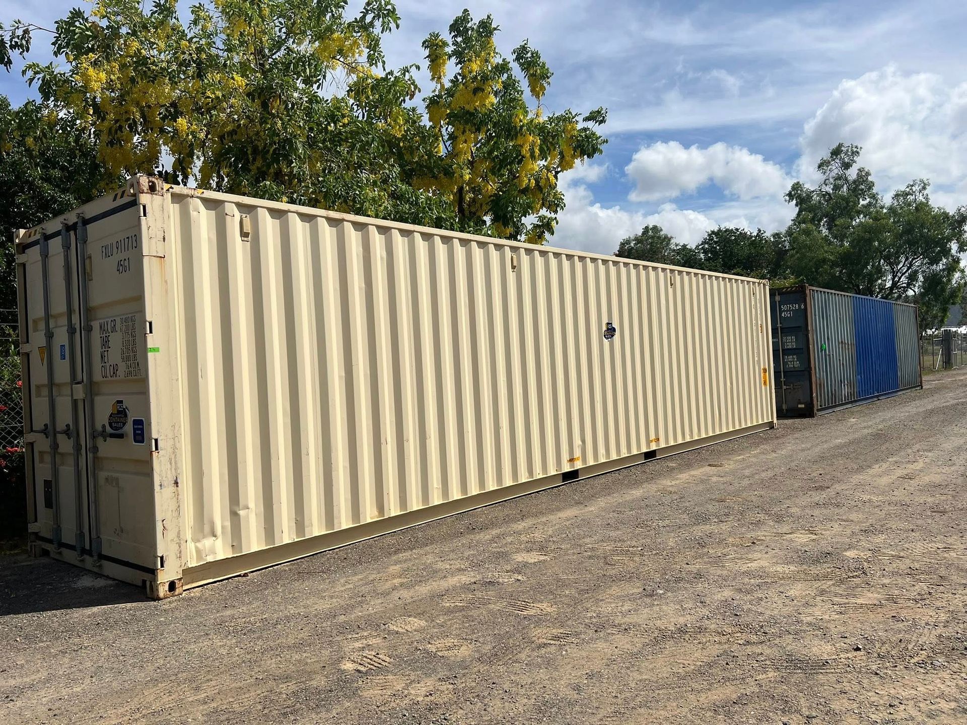 Two White Shipping Containers, Standing Outdoors on Gravel, Under a Blue Sky  — Rockhampton Container Sales in Kawana, QLD