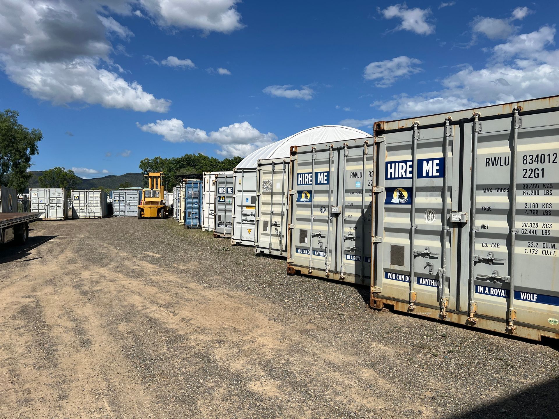 Beige Shipping Container Outdoors, Next to Other Containers, Under a Cloudy Sky  — Rockhampton Container Sales in Kawana, QLD