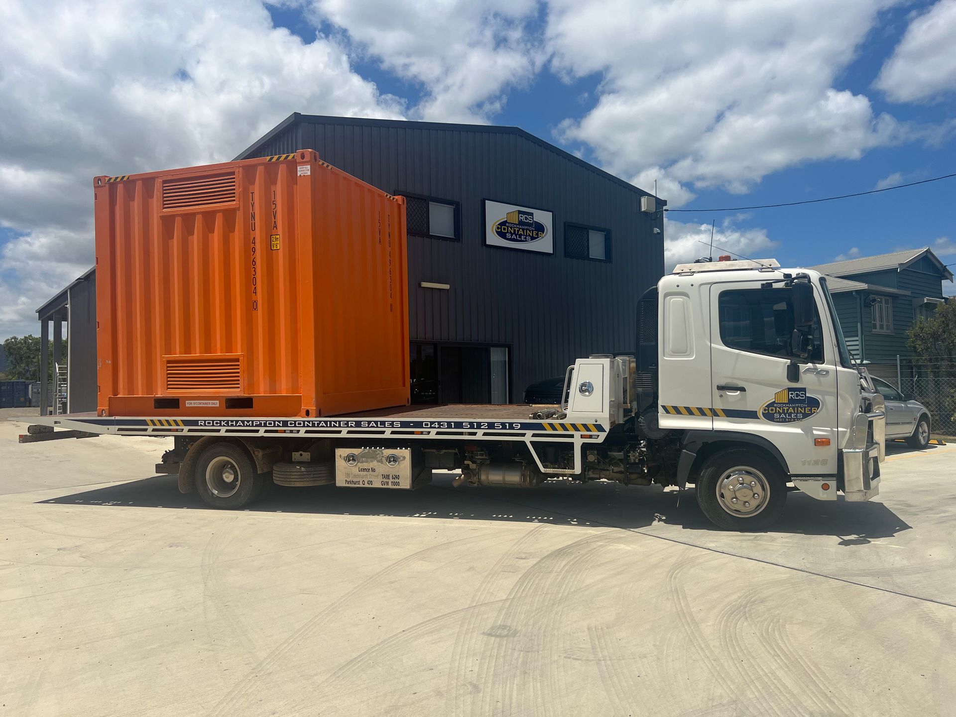 Green Shipping Container Against a Blue Sky, Outdoors on Gravel  — Rockhampton Container Sales in Kawana, QLD