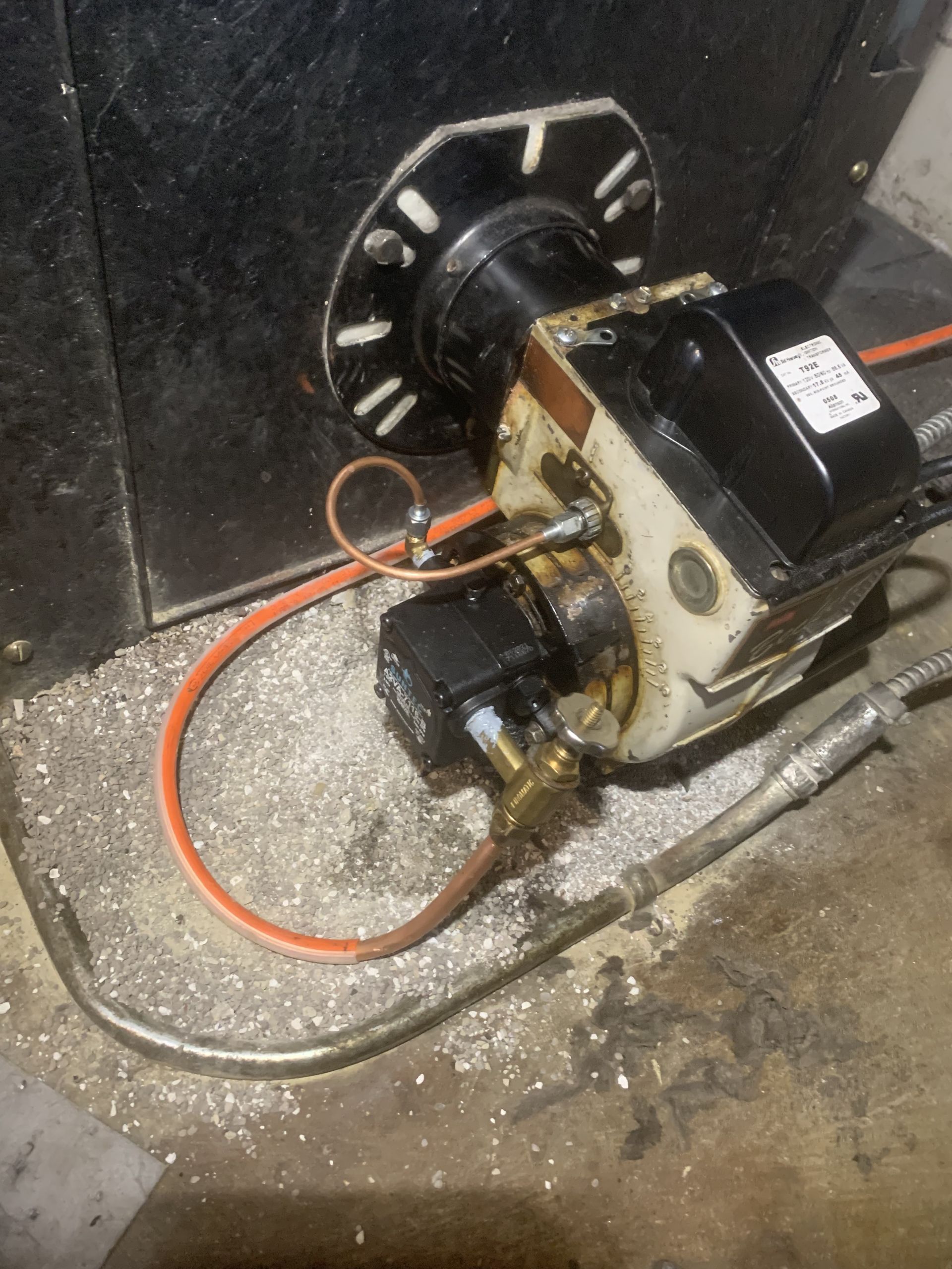 A close up of a heater with a hose attached to it