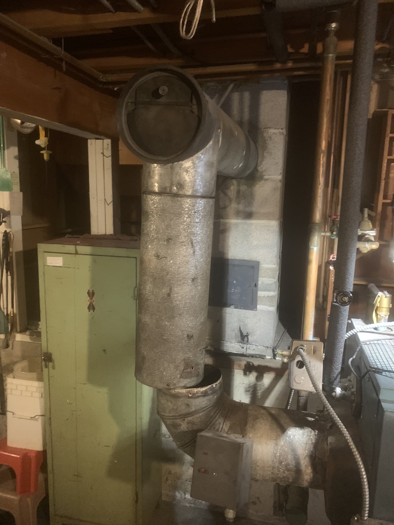 A large metal pipe is hanging from the ceiling of a room.