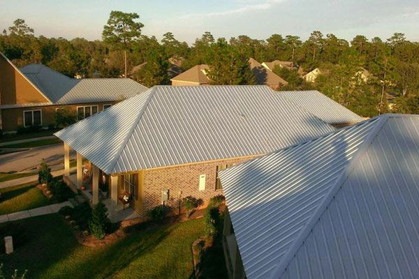 An aerial view of a house with a metal roof