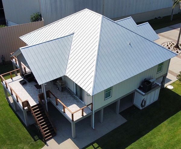 An aerial view of a house with a metal roof