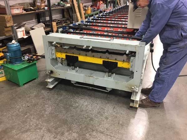 A man is working on a machine in a factory.