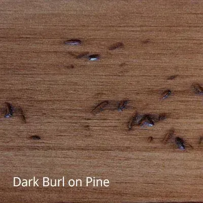Close-up of wood grain. Dark burl on a light brown pine surface.