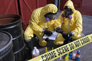 Two men in protective suits are working on a crime scene.