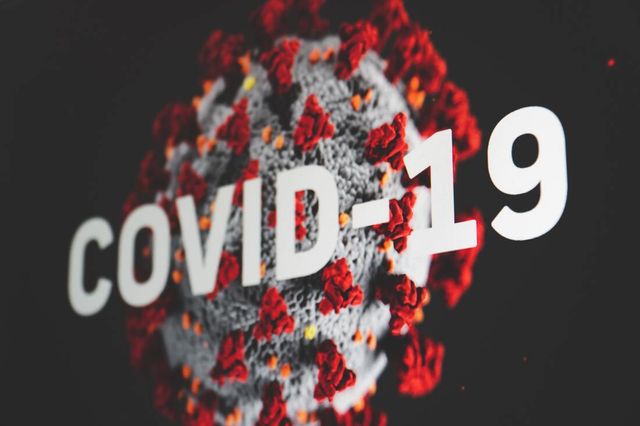 A close up of a covid-19 virus on a black background.