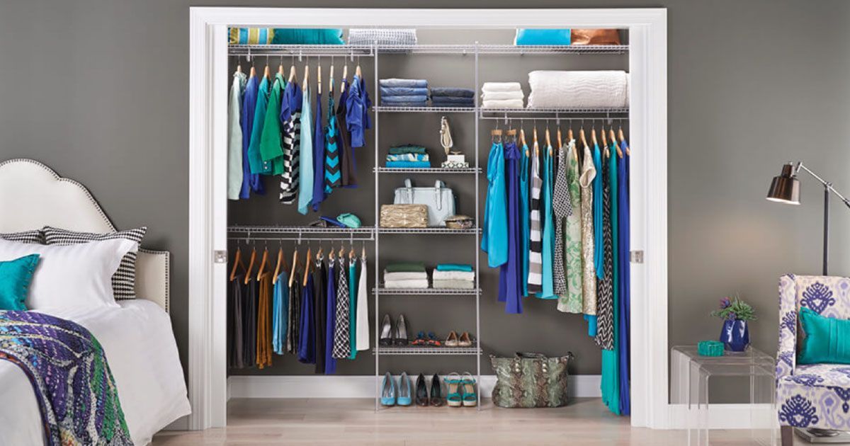 a bedroom with a closet filled with clothes and a bed .