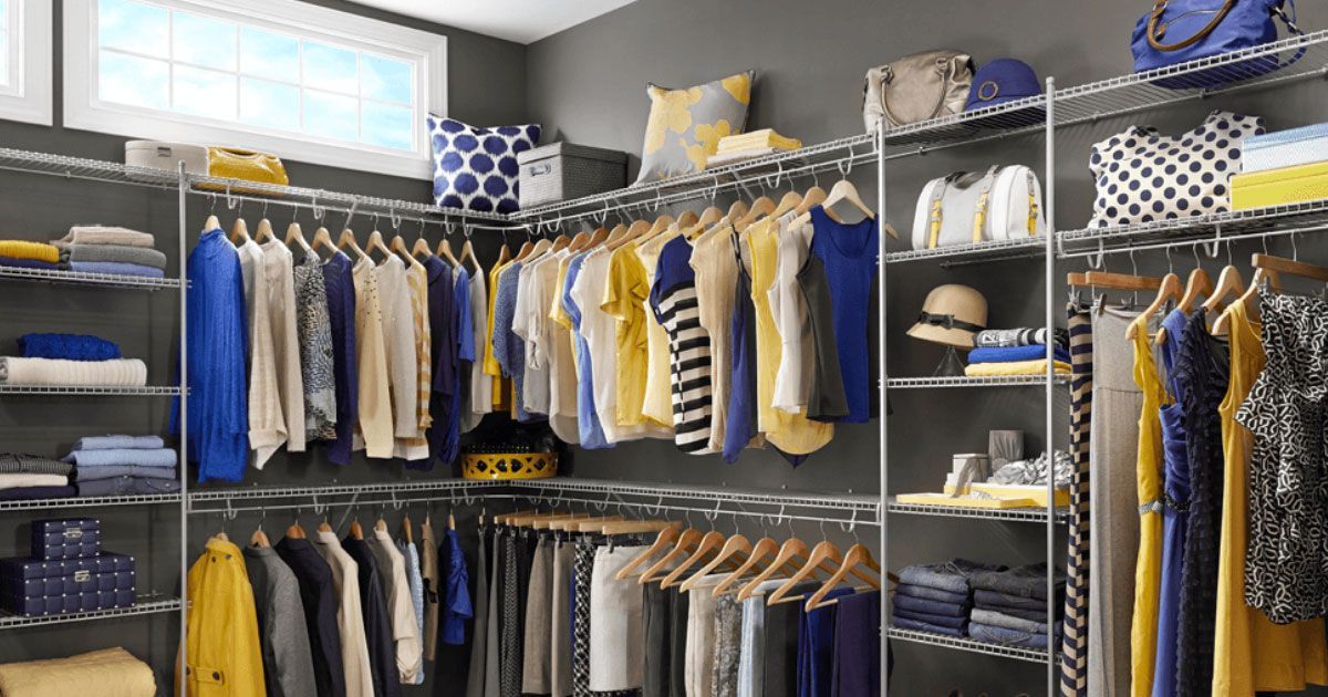 a walk in closet filled with lots of clothes and hats .