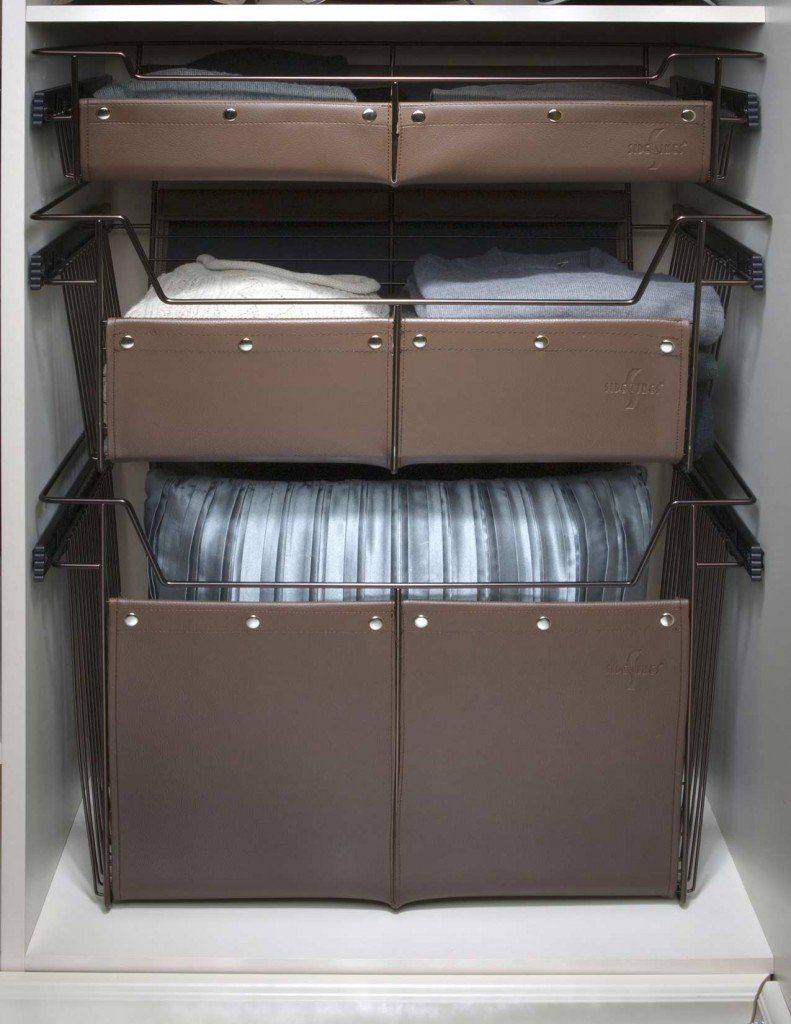 sliding basket system with lots of clothes and drawers .