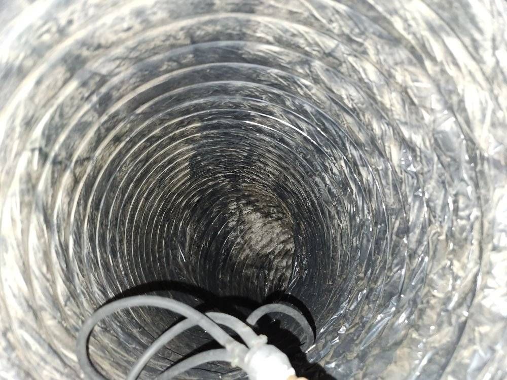 The inside of a duct with wires coming out of it