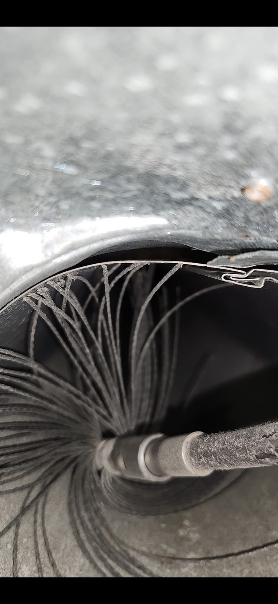 A close up of a tire with a hole in it.