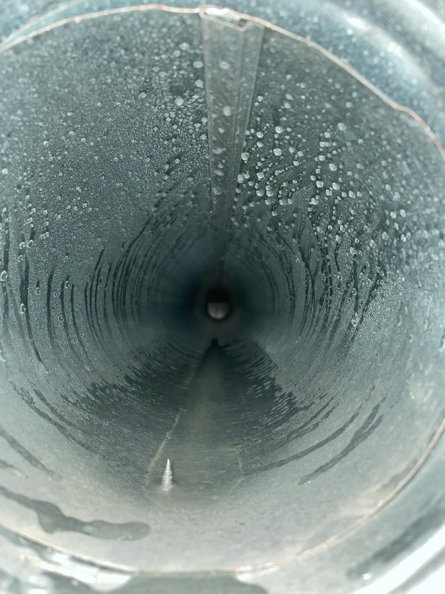 A close up of the inside of a metal pipe.