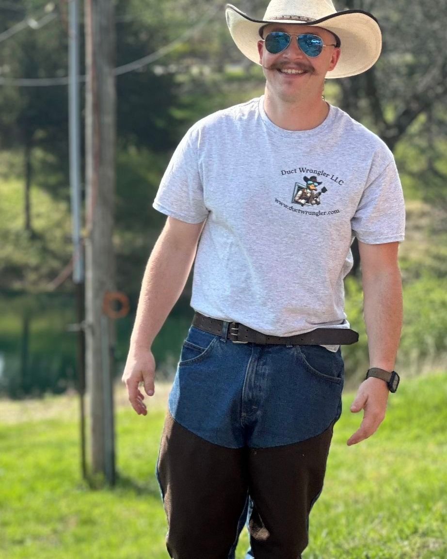 A duck wearing a cowboy hat and sunglasses is holding a drill and brush.