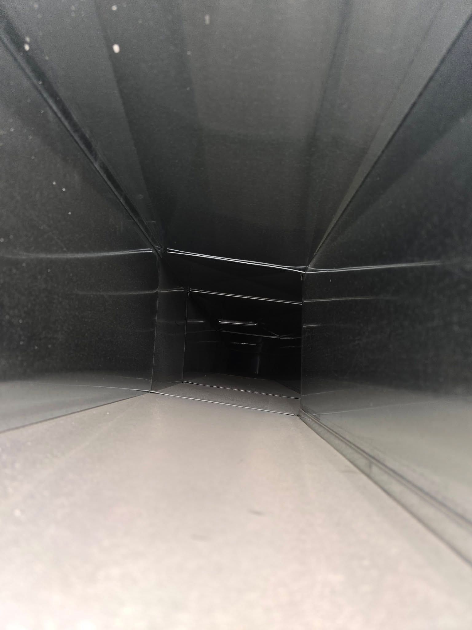 A close up of a black duct that looks like a tunnel.