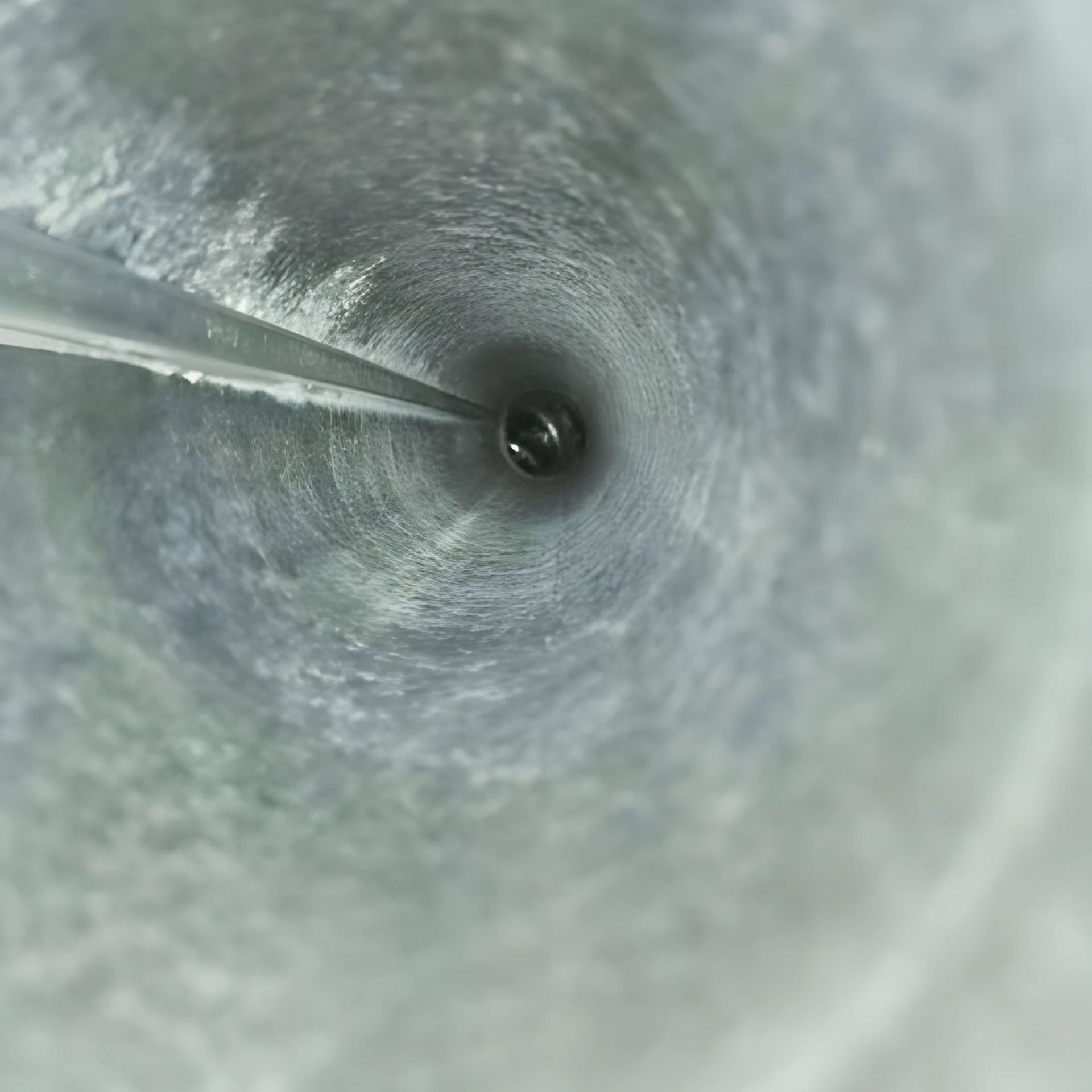 Duct Wrangler, LLC - Inside view of a metal duct, likely for ventilation. The passage.