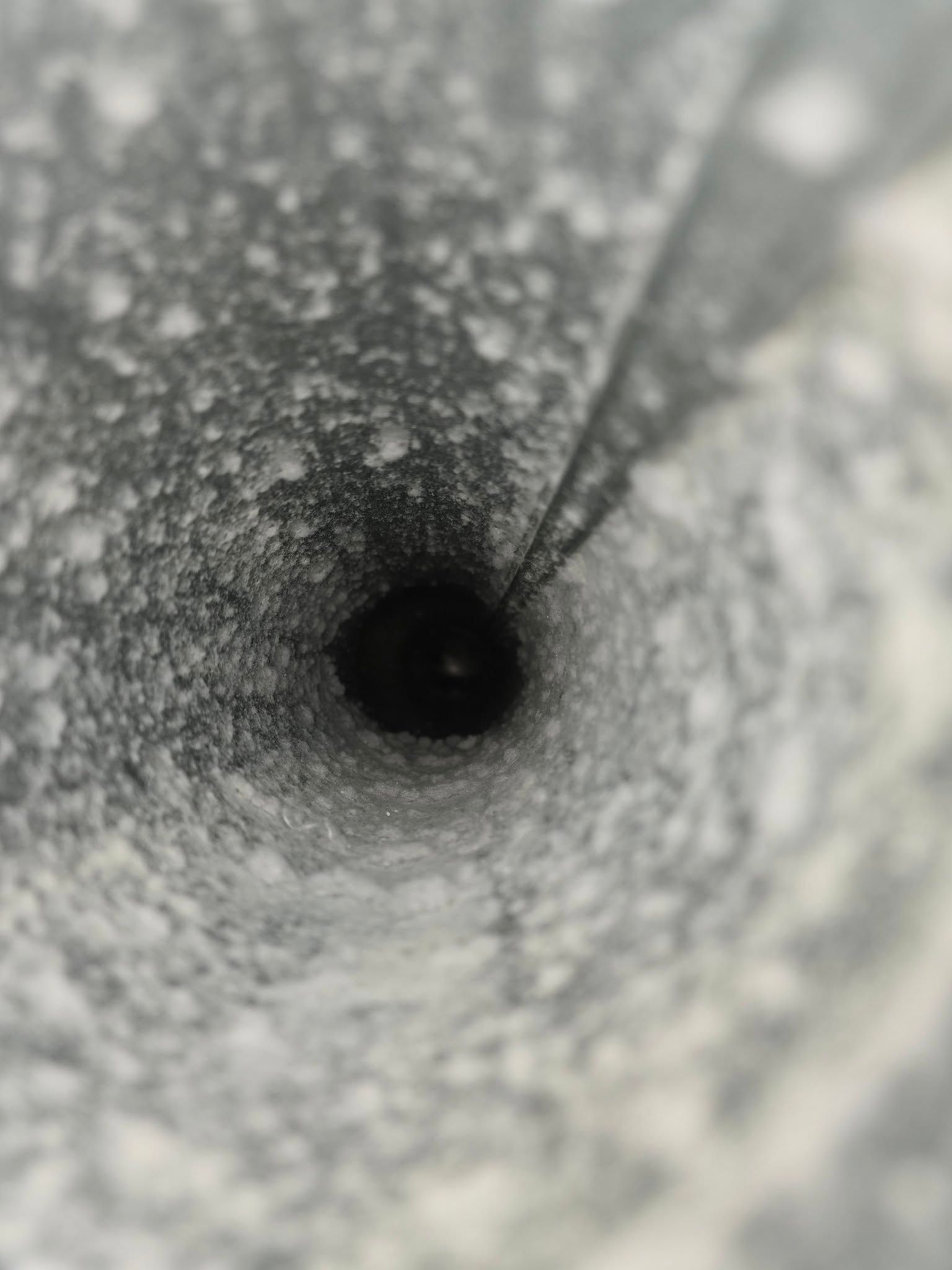 A black and white photo of a hole in the ground.