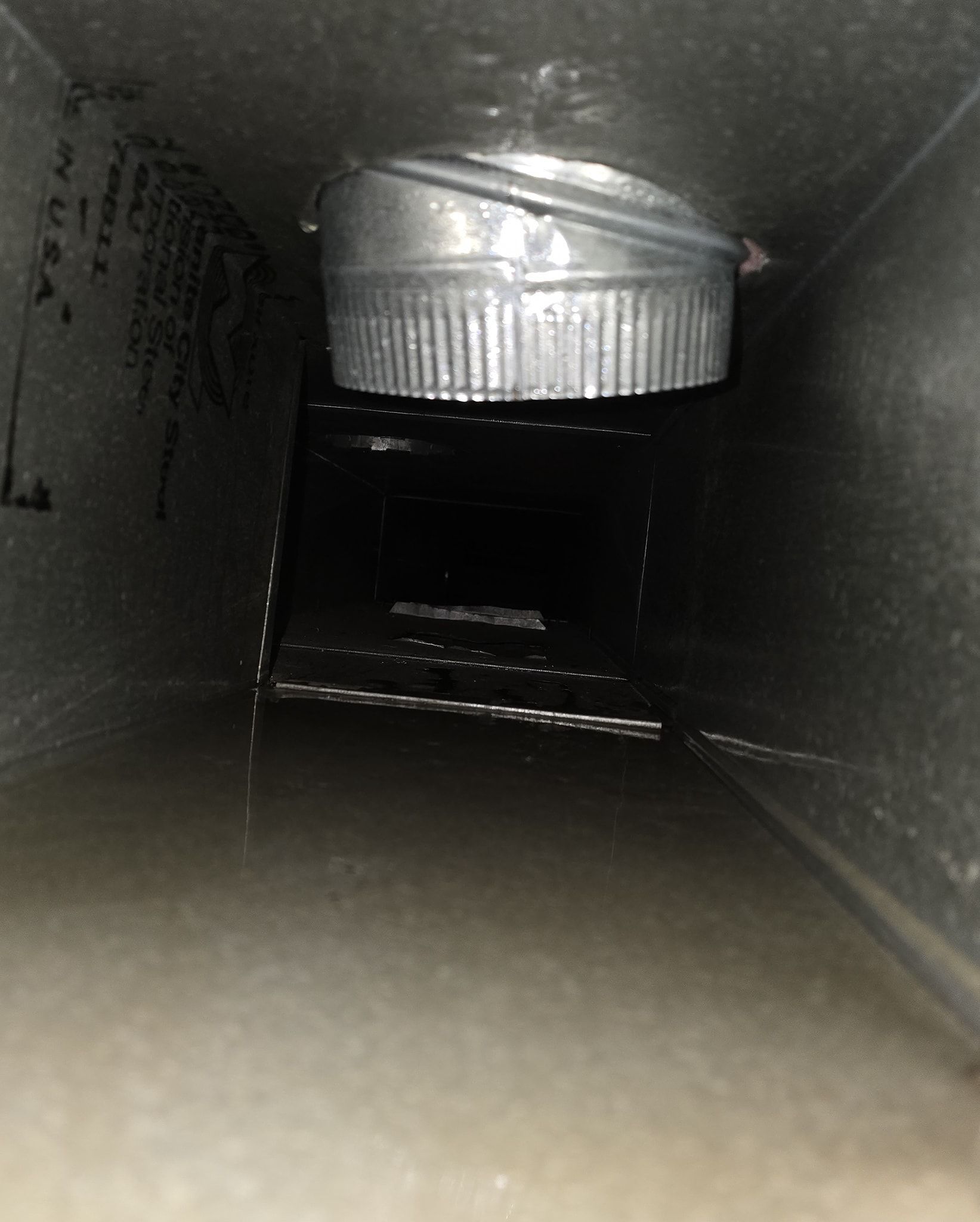 A close up of a metal pipe in a room.